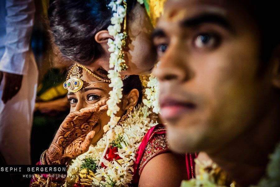 During a wedding in Chennai, I could see the bride was going to cry so I picked up my second camera with 35mm lens and waited for this shot to happen. A split second later she wiped the tear and was smiling again. (Nitya & Sharath's Tamil-Brahmin wedding in Chennai)
