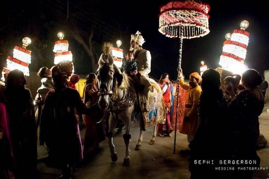 A baraat procession during a Hindu punjabi wedding. I wanted to get the shot of the people carrying the lamps and had to work without a flash for that or I would have changed the image completely and loose the entire feel of the night lit by the lanterns. The light falling on the bridegroom and his horse came out just the way I had hoped. (Karishma & Rishabh's wedding in Delhi)