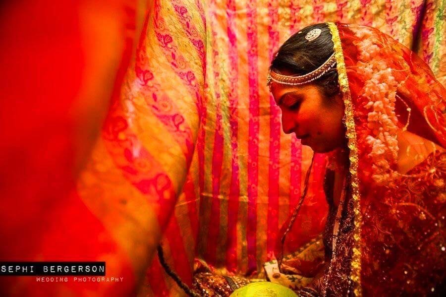A bride waiting for her husband-to-be behind a veil during a wedding in Andra Pradesh. I had to pick up the veil and almost go in with her in order to get this intimate picture of solitude. (Sameera & Pradeep's wedding in Visakhapatnam)