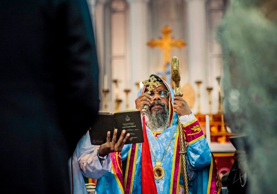 A Syrian Christian priest performs a wedding in Kerala. Syrian Christians claim to be descended from high caste Hindus, converted to Christianity by St. Thomas. A Syrian Christian wedding is combination of biblical, Hindu and indigenous customs of south India.